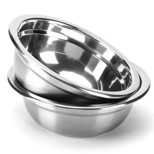 Two COMESOON stainless steel dog bowls stacked, showing polished interior and flat rim, on a white background